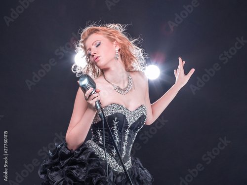 Canvas Print stylish young singer with a microphone performing a jazz song.