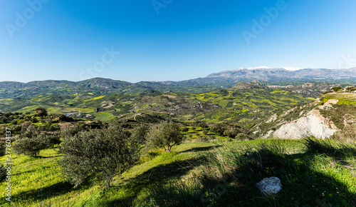 Aerial view of rural Archanes region landscape. Unique scenic panorama Olive groves, vineyards, green meadows and hills view in spring. Heraklion, Crete, Greece