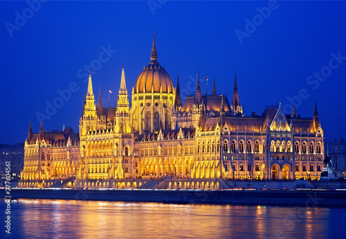 The spectacular Hungarian Parliament next to Danube river, on the side of Pest, as seen from the side of Buda. Budapest, Hungary. It is one of the largest parliaments of the world.