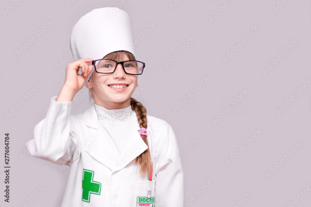 Smiling little girl in medical uniform and glasses looking at camera isolated on white Smiling little girl in medical uniform and glasses looking at camera isolated on white