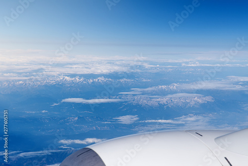 Endless cloudy sky, view from the airplane. Airline theme, travel and business trip by plane