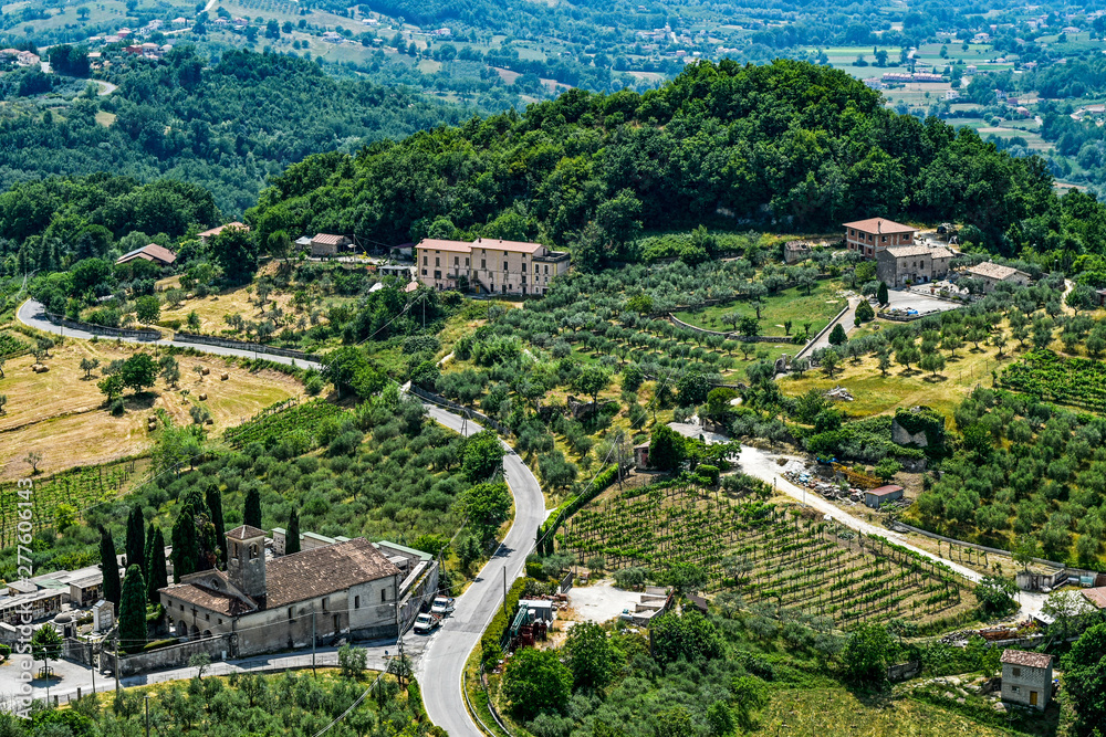 Italian landscape of agricultural hills in Picinisco with medieval cemetery church of Santa Maria