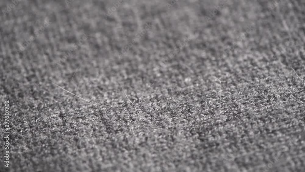 Wool background. Grey wool clothes texture closeup, dolly shot. Knitted soft gray merino wool macro shot. Natural woolen fabric. 4K UHD video footage. 3840X2160 Wool background. Grey wool clothes texture closeup, dolly shot. Knitted soft gray merino wool macro shot. Natural woolen fabric. 4K UHD video footage. 3840X2160