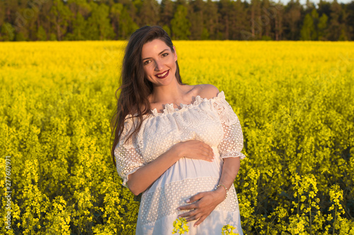 Happy pregnant girl waiting for twins. Belly of a pregnant woman. Twins © SYARGEENKA