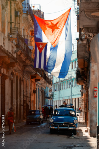 Fotografie Antique car and cuban flag in Old Havana