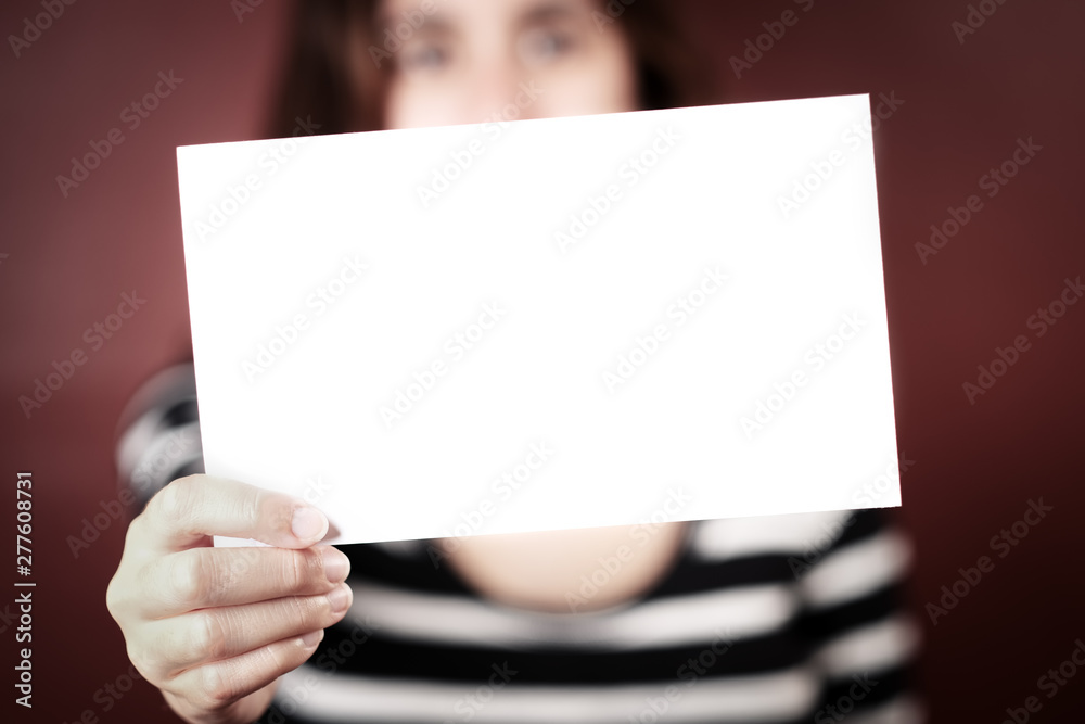 Serious young adult woman holding a blank sign Serious young adult woman holding a blank sign