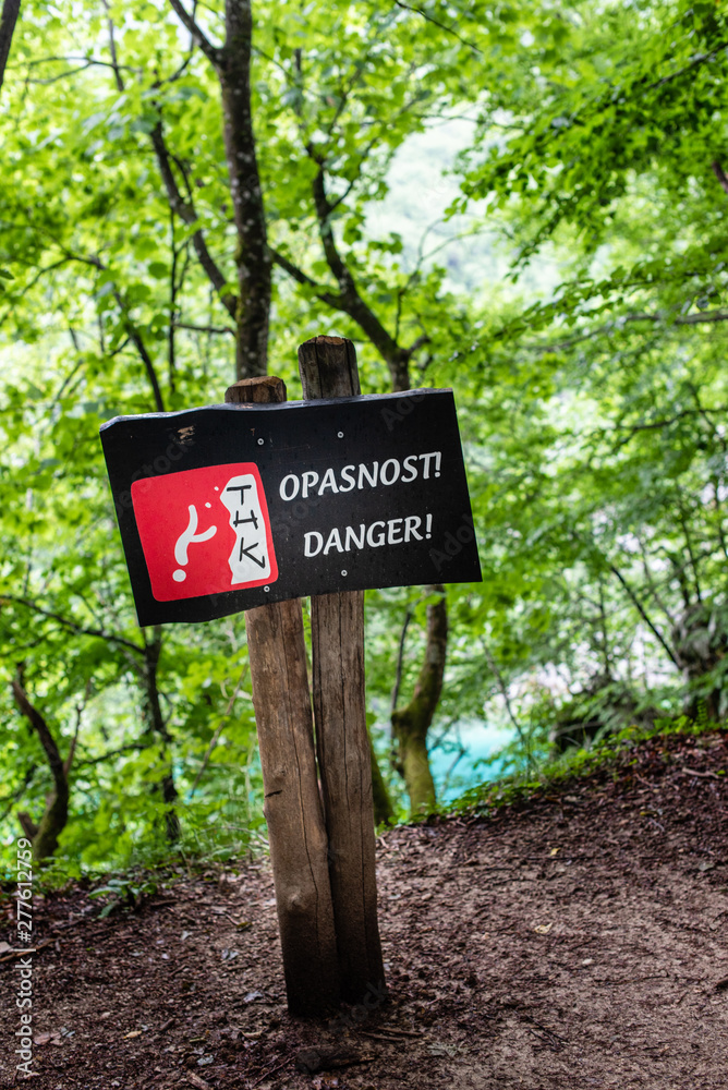 Danger, Opasnost, sign warning of falling from high cliff in the Plitvice Lakes national park Croatia Danger, Opasnost, sign warning of falling from high cliff in the Plitvice Lakes national park Croatia