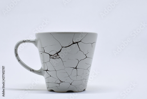 beige color, ceramic mug, with crack pattern, isolated