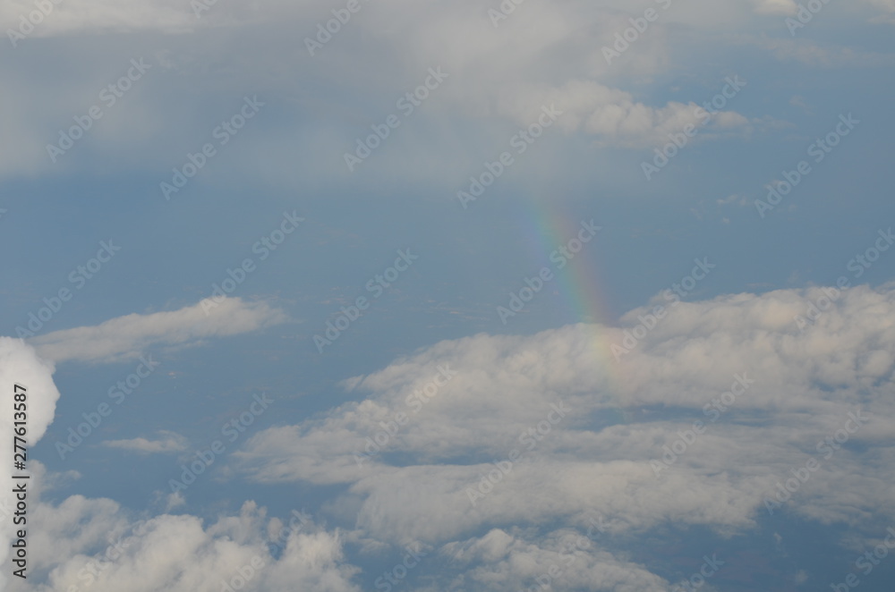 Flying High Amongst the Clouds with a Rainbow