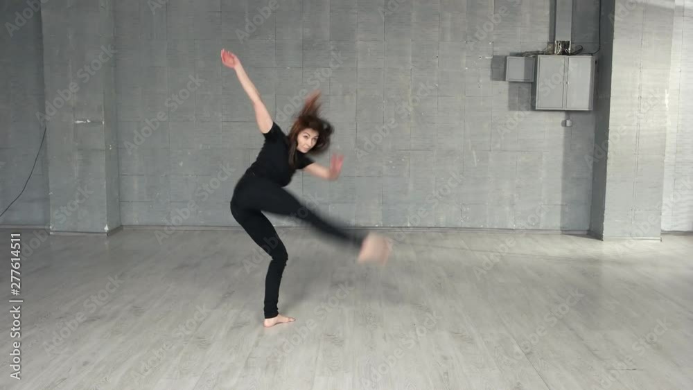 Pretty slim woman performing dance moves in studio. Contemporary style dancer practicing indoor. People, choreography and lifestyle concept. Pretty slim woman performing dance moves in studio. Contemporary style dancer practicing indoor. People, choreography and lifestyle concept.