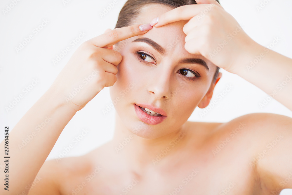 Naklejka premium Problem Skin. Woman Crushing Spot On Face And Looking In Mirror