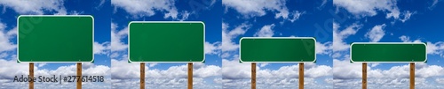 Set of Different Sized Blank Green Road Signs Over Clouds and Blue Sky