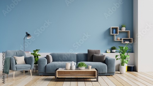 Interior of a bright living room with pillows on a sofa and armchair, plants and lamp on empty blue wall background. 3D rendering