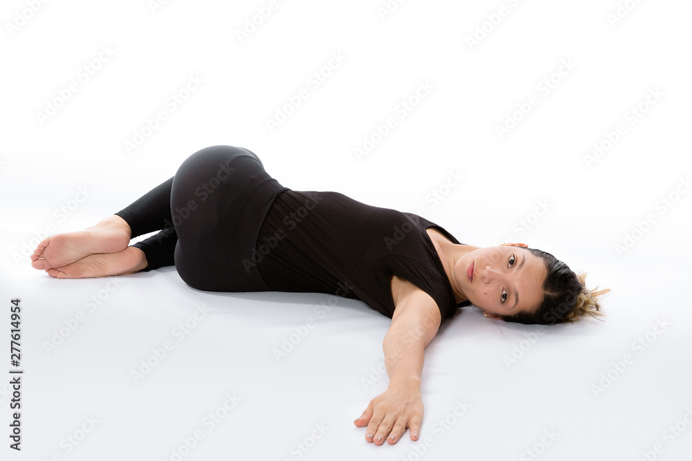 Foto Stock Supta Matsyendrasana yoga pose (Reclined Spinal Twist pose).  Yoga poses woman isolated with white background. Yoga pose set. Mindfulness  and Spiritually concept. Girl practicing Hatha Yoga asanas | Adobe Stock