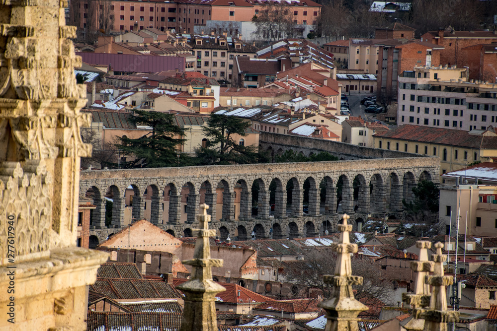 The Aqueduct of Segovia peaking through the city's skyline. 