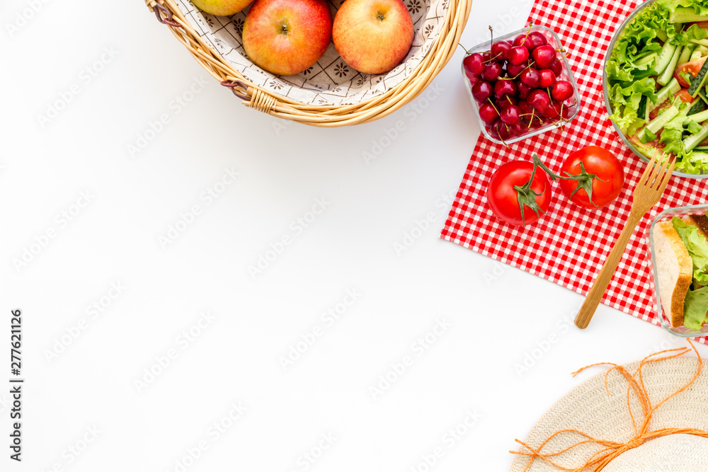 picnic in summer with products, sandwich, salad, fruits and hat on white background top view space for text - obrazy, fototapety, plakaty 