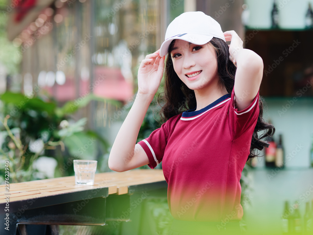 Modern Girl Wearing Casual Clothes And A Cap Posing Outdoor