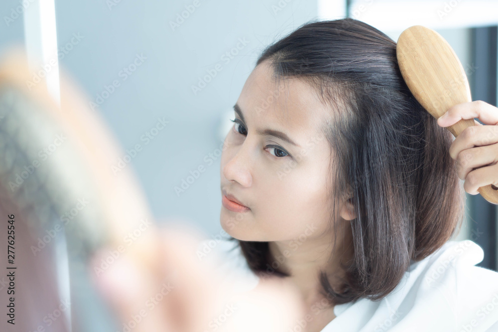 Fototapeta premium Woman looking reflection in the mirror serious hair loss problem for health care shampoo and beauty product concept
