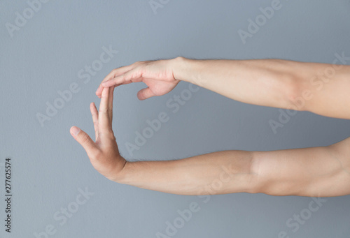 stretching exercises finger on grey background, health care and medical concept photo