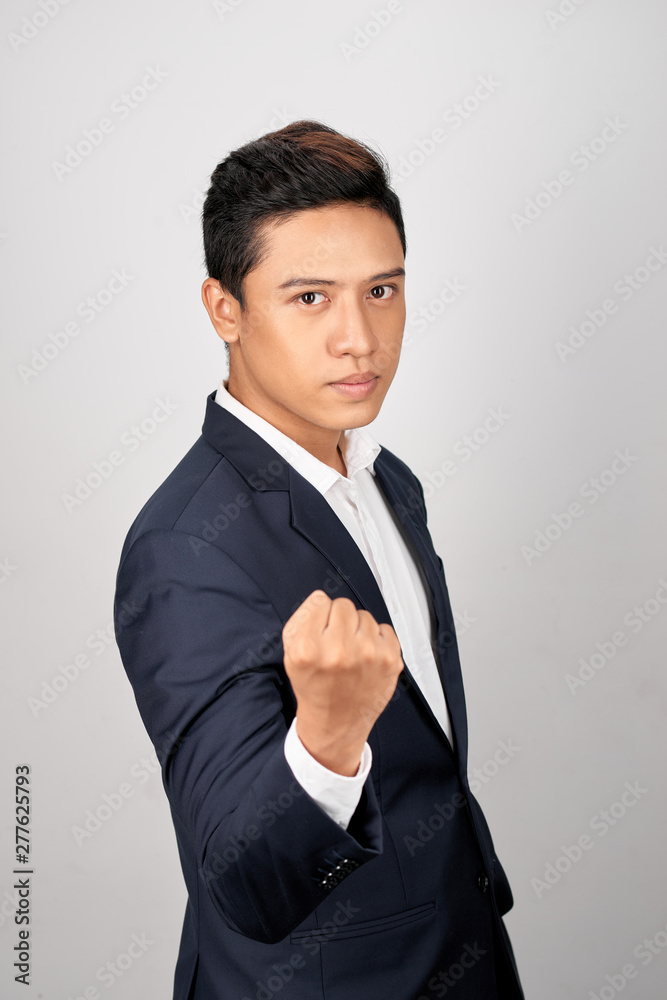 Young businessman showing a fist bump over white background Young businessman showing a fist bump over white background