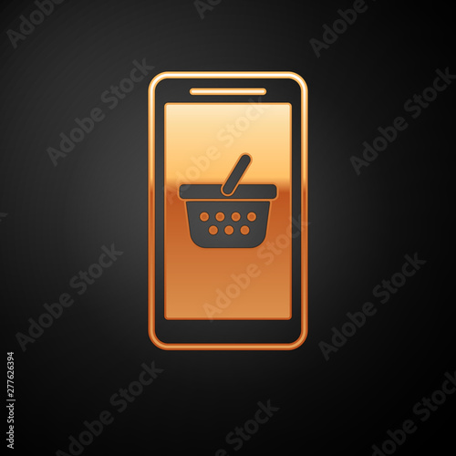 Gold Mobile phone and shopping basket icon isolated on black background. Online buying symbol. Supermarket basket symbol. Vector Illustration