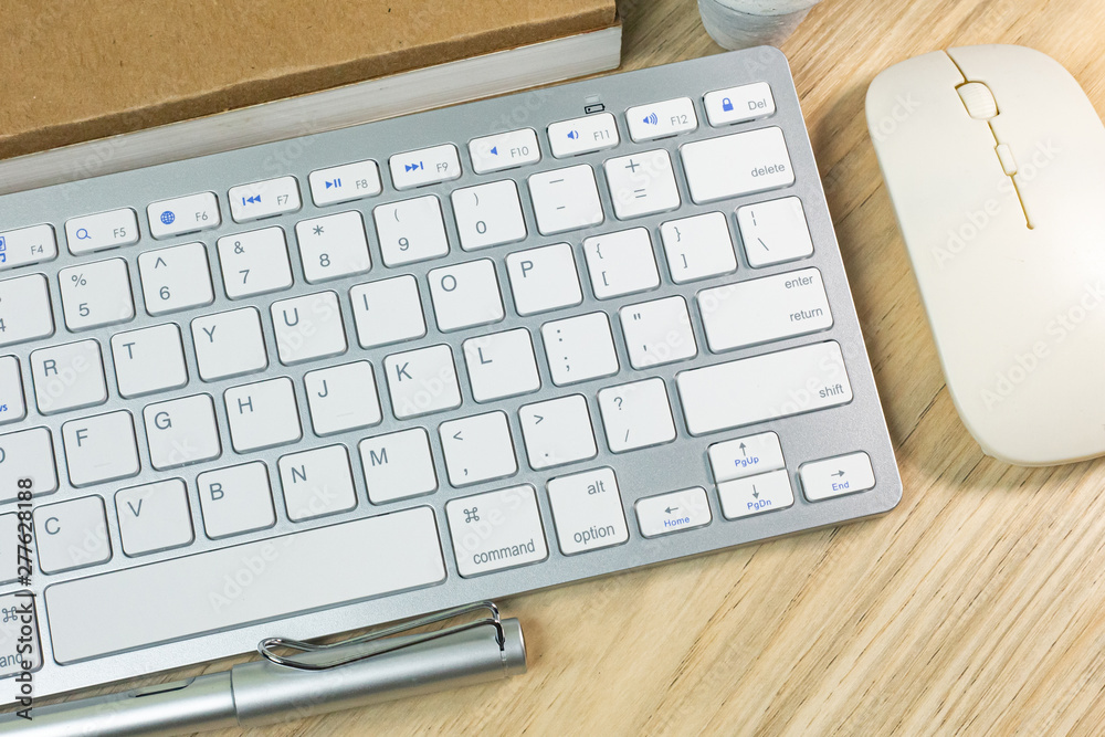 silver keyboard on wood table flat lay image.. silver keyboard on wood table flat lay image..