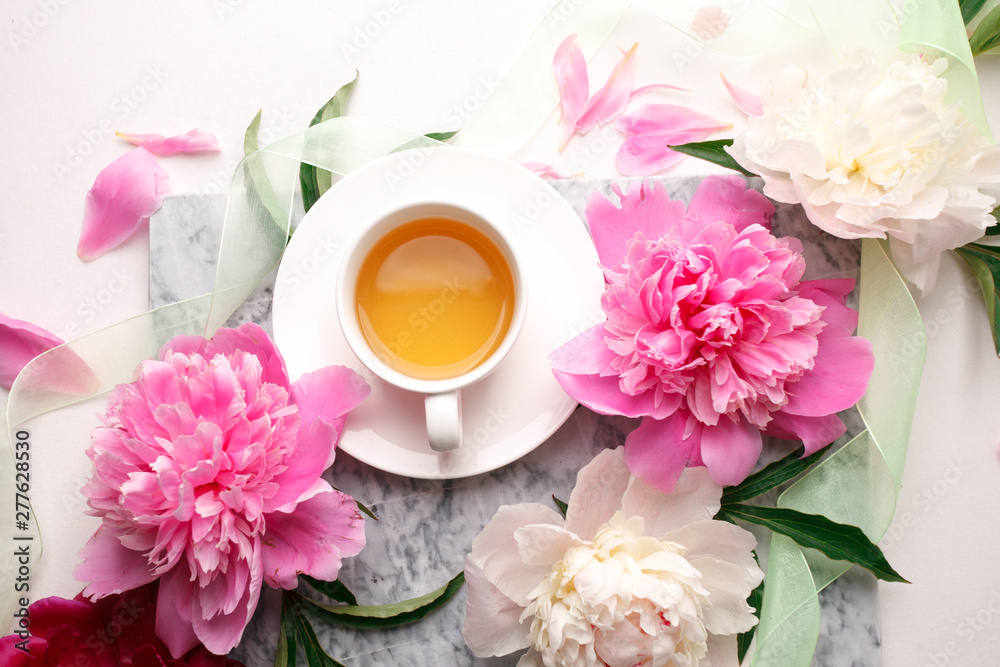 Creative layout with pink white peonies flowers and cup of tea on bright table. Spring Seasonal valentine, woman, mother, 8 march holiday, romance breakfast