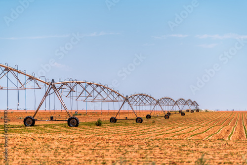 Brownfield, USA Texas rural countryside industrial field with water or fertilizer chemicals sprayer on dry land