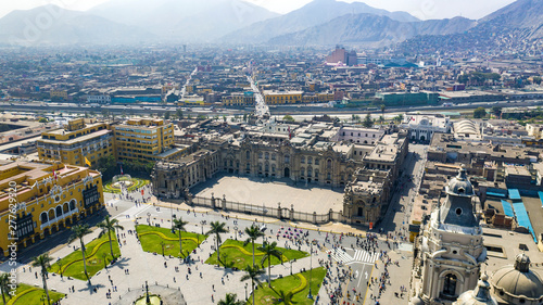 Fototapeta Naklejka Na Ścianę i Meble -  Aerial view of Lima main square, government palace of Peru and cathedral church. Tourists and people gathered at 