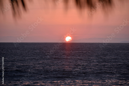 Sunset at the Beach with Thatched Roof photo