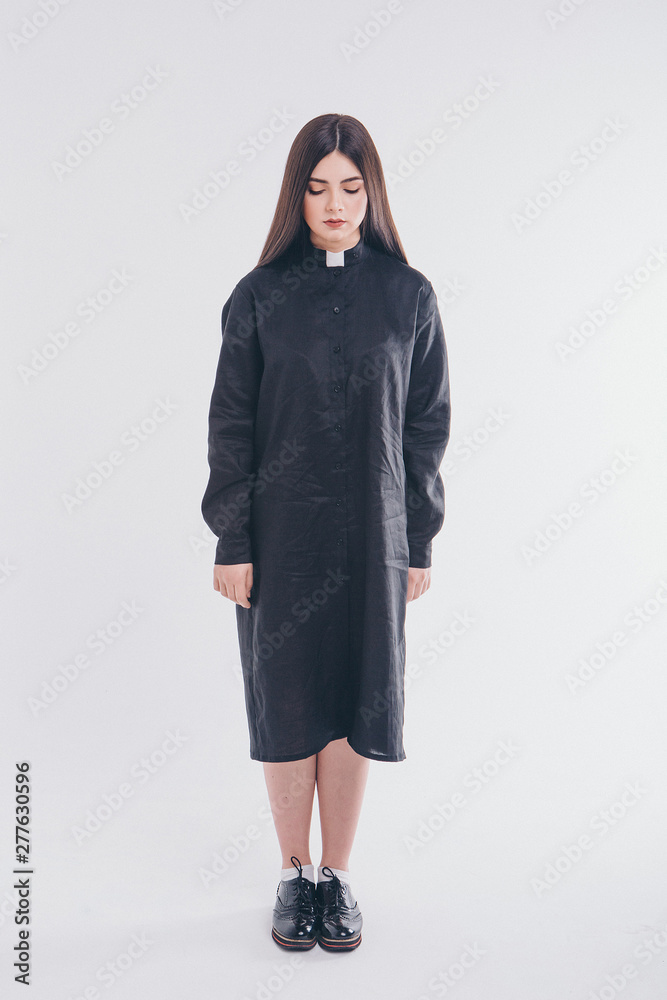 nun on white background. A girl in a black shirt with a white collar. the concept of Church education