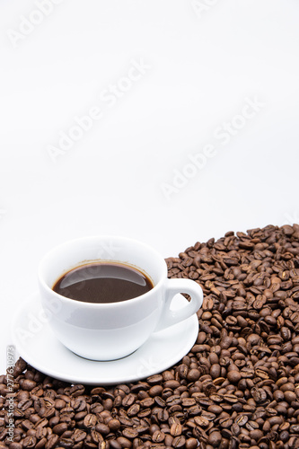 white cup of coffee with coffee bean on white background © Sitthikorn