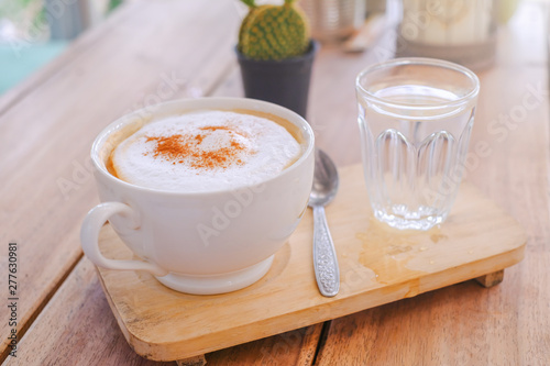 Wallpaper Mural cappucino coffee in white white  cup and drinking water is served on wooden table Torontodigital.ca