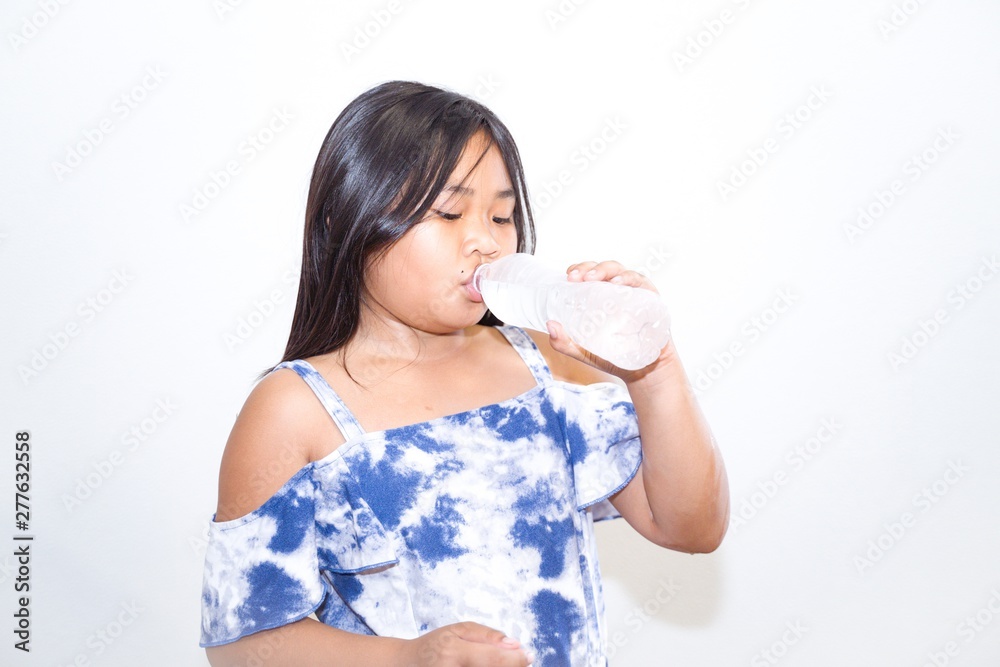 portrait of a girl. little girl feel drink in studio shot. portrait of a girl. little girl feel drink in studio shot.