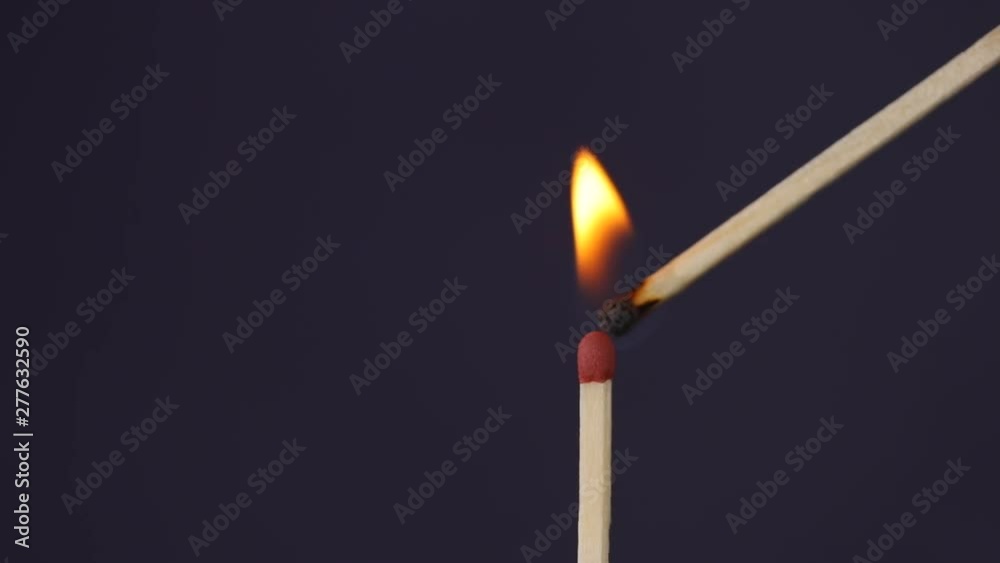 Ignition matches hand close up macro shot captured in front of black background in slow motion at 120 fps. Ignition matches hand close up macro shot captured in front of black background in slow motion at 120 fps.