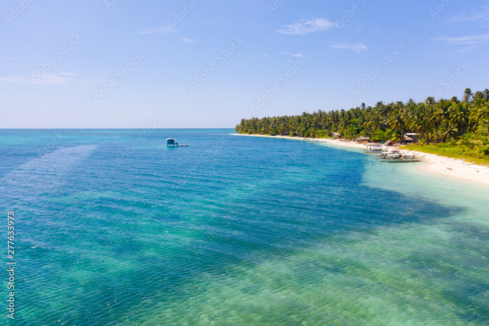 Large tropical island white sandy beach, view from above. Seascape, nature of the Philippine Islands. Tropical forest and sea lagoons.