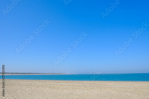 Beautiful Beach With Crystal Clear Blue Waters of The Sea Against Blue Sky on a summers day