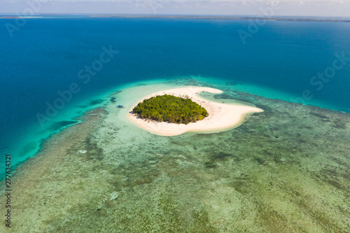 Patawan island. Small tropical island with white sandy beach. Beautiful island on the atoll, view from above. Nature of the Philippine Islands.