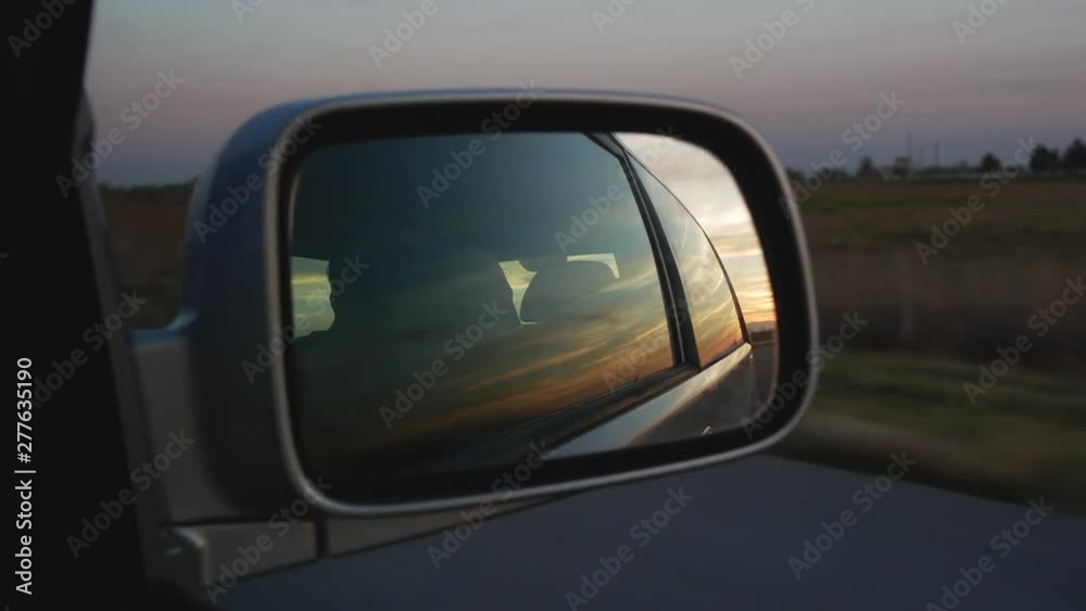 Sunset View In Right Side Mirror In Car Driving On The Road Sunset View In Right Side Mirror In Car Driving On The Road