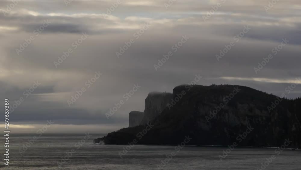 Timelapse of a Striking landscape of a rocky coastline during a cloudy sunrise. Taken in Forillon National Park, near Gaspe, Quebec, Canada. Timelapse of a Striking landscape of a rocky coastline during a cloudy sunrise. Taken in Forillon National Park, near Gaspe, Quebec, Canada.