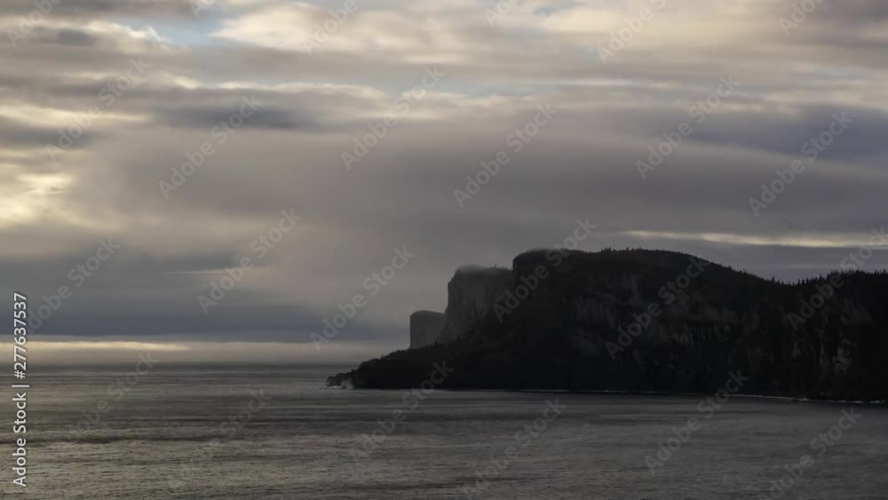 Timelapse of a Striking landscape of a rocky coastline during a cloudy sunrise. Taken in Forillon National Park, near Gaspe, Quebec, Canada. Timelapse of a Striking landscape of a rocky coastline during a cloudy sunrise. Taken in Forillon National Park, near Gaspe, Quebec, Canada.