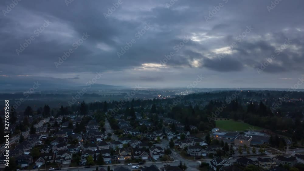Aerial view of Residential homes in a modern city during a cloudy summer sunrise. Taken in Surrey, Vancouver, BC, Canada. Aerial view of Residential homes in a modern city during a cloudy summer sunrise. Taken in Surrey, Vancouver, BC, Canada.