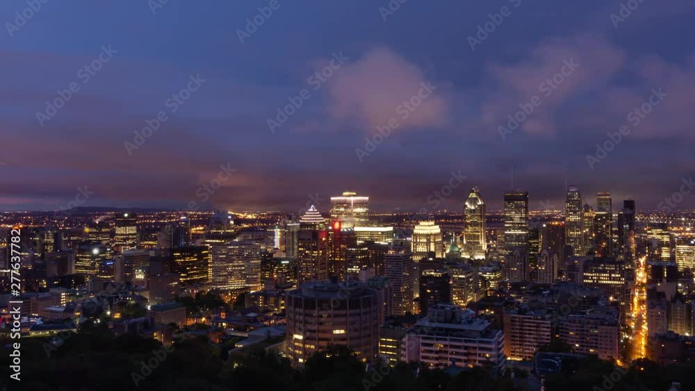 Aerial Time Lapse of a beautiful modern downtown city during a striking cloudy sunrise. Taken in Mt Royal, Montreal, Quebec, Canada. Aerial Time Lapse of a beautiful modern downtown city during a striking cloudy sunrise. Taken in Mt Royal, Montreal, Quebec, Canada.