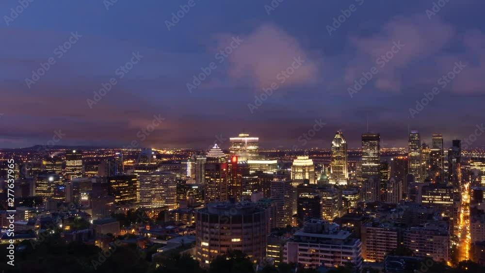 Aerial Time Lapse of a beautiful modern downtown city during a striking cloudy sunrise. Taken in Mt Royal, Montreal, Quebec, Canada. Aerial Time Lapse of a beautiful modern downtown city during a striking cloudy sunrise. Taken in Mt Royal, Montreal, Quebec, Canada.