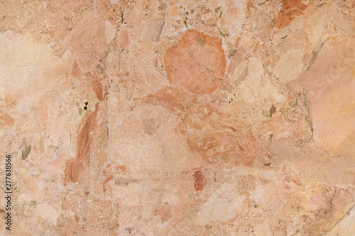 background of old cracked natural marble of red, yellow color with spots of different size and color
