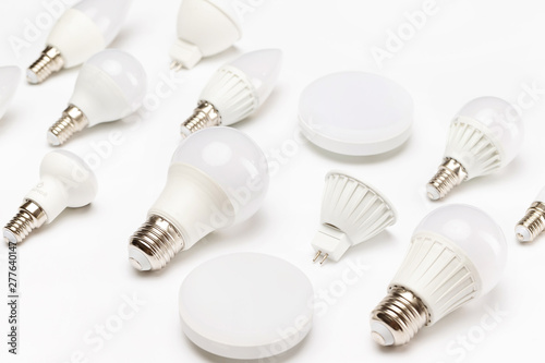 Group of different energy saving lamps isolated at yellow background.