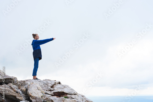 Mid age woman taking selfie at the top of mountains