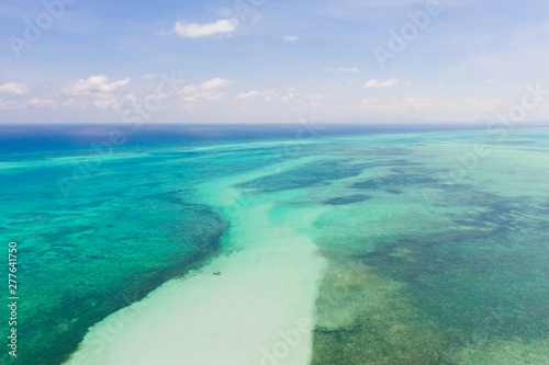 Coral reefs and atolls in the tropical sea, top view. Turquoise sea water and beautiful shallows. Philippine nature.