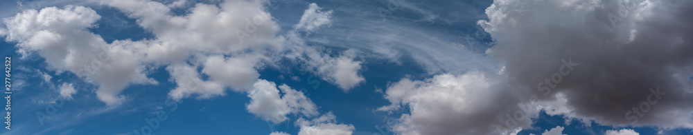 white clouds float across the blue sky white clouds float across the blue sky
