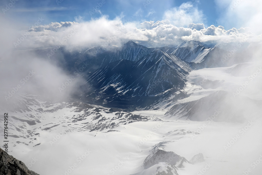 Fototapeta premium Cloudy mountainous landscape. View at South Chuya Mountain Range from slope of IIktu Peak. Altai Republic, Siberia, Russia.
